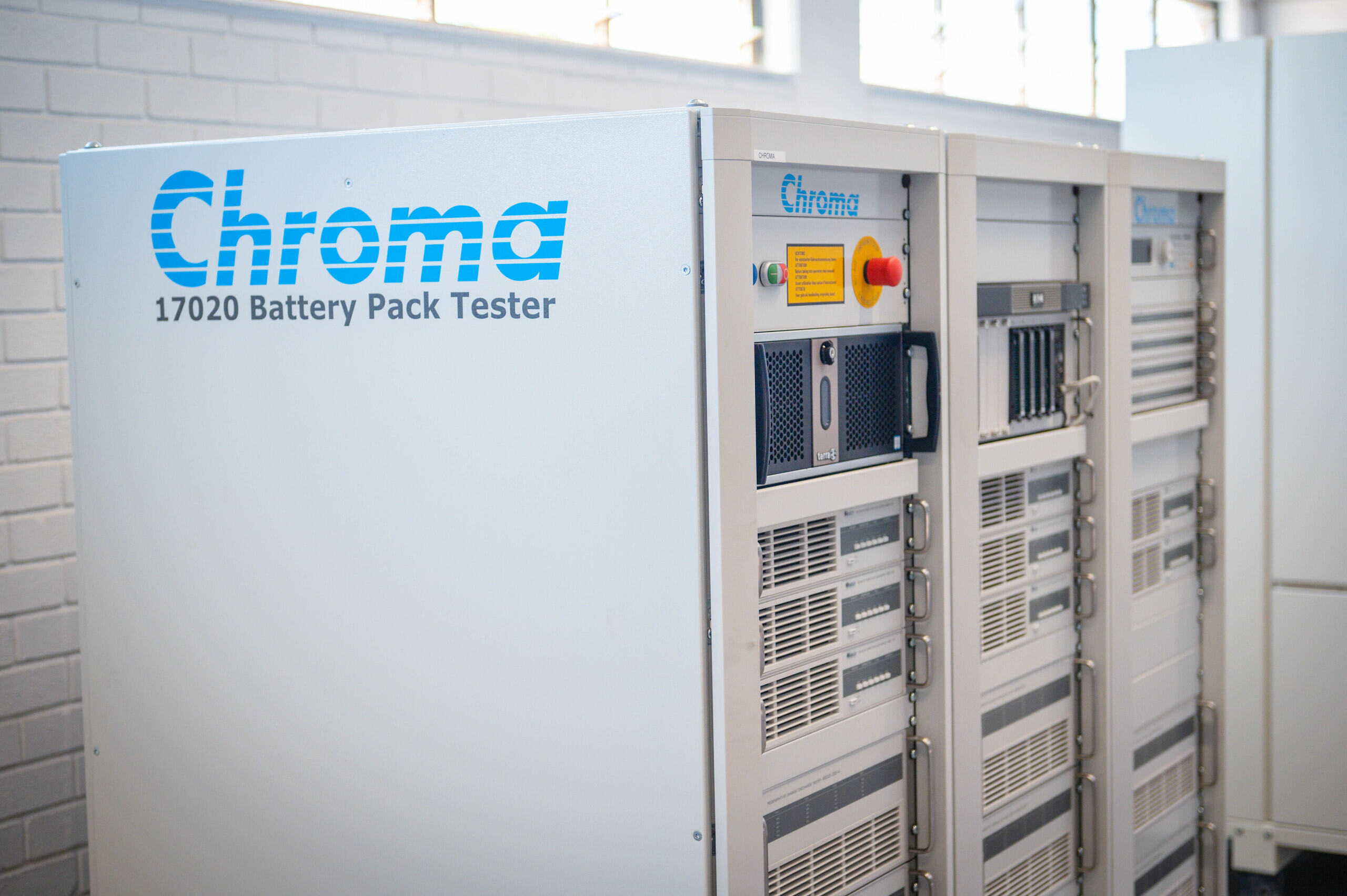 Hand holding a container with yellowish liquid