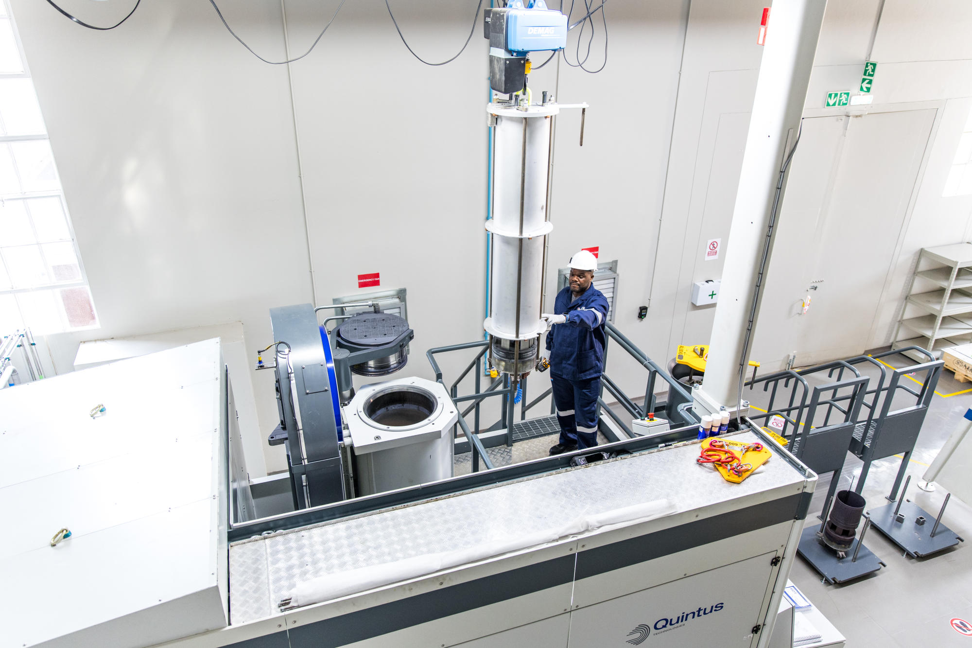 Hand holding a container with yellowish liquid