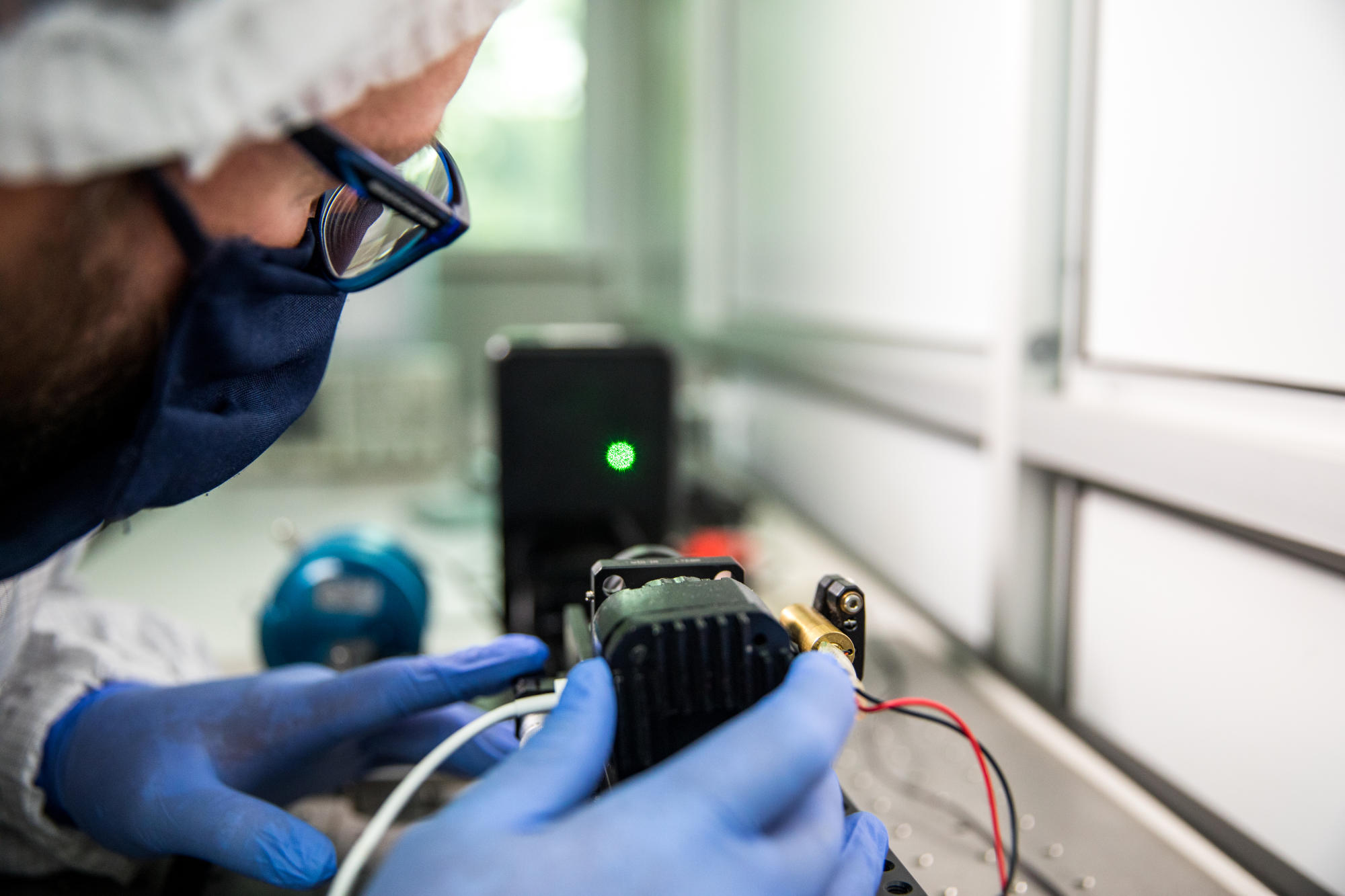 Hand holding a container with yellowish liquid