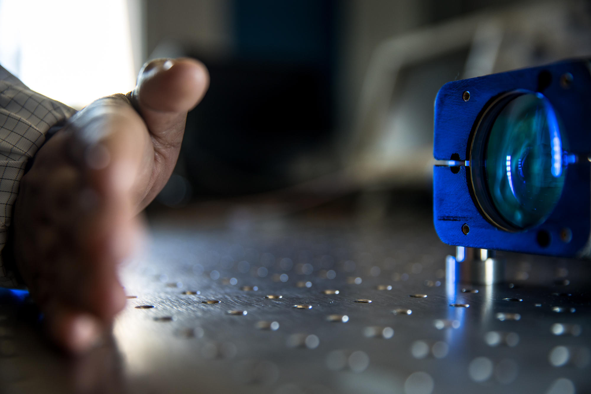 Hand holding a container with yellowish liquid