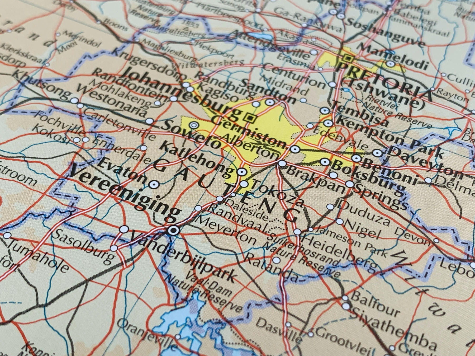 Hand holding a container with yellowish liquid