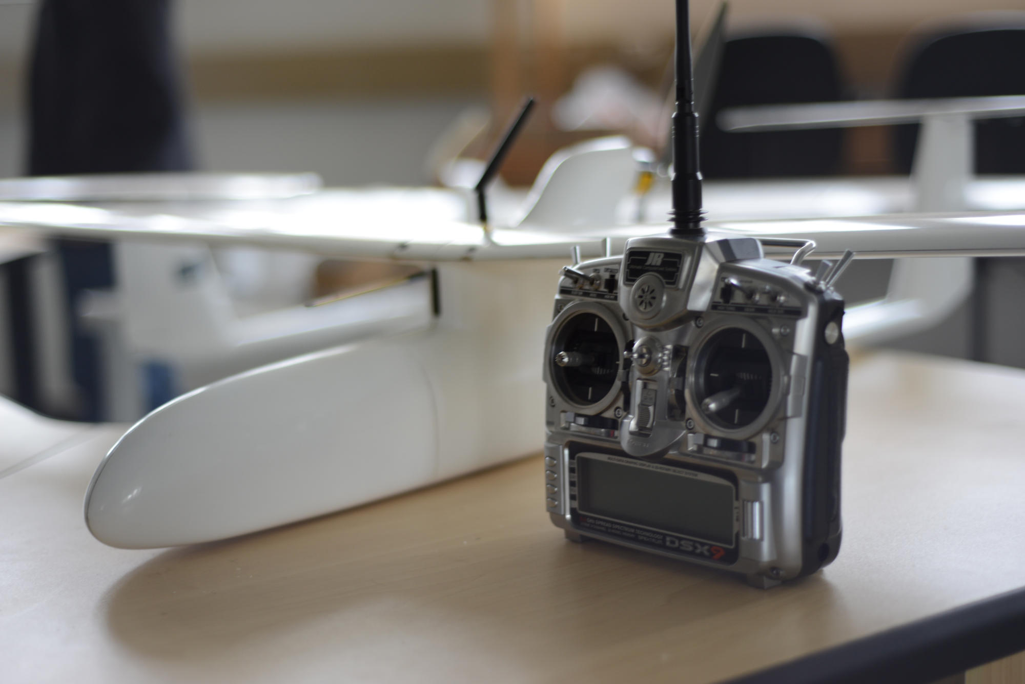 Hand holding a container with yellowish liquid