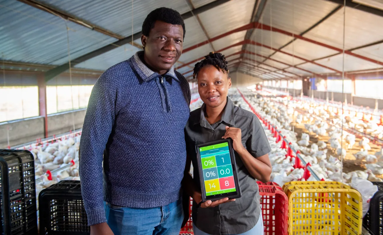Man and woman showcasing a tablet
