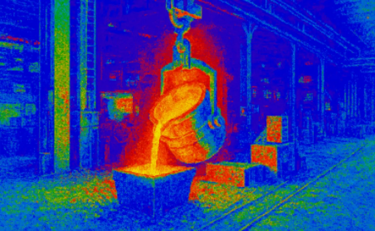 Hand holding a container with yellowish liquid