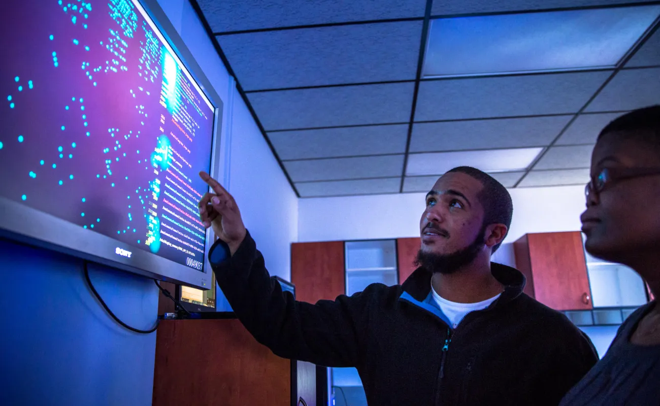 Hand holding a container with yellowish liquid