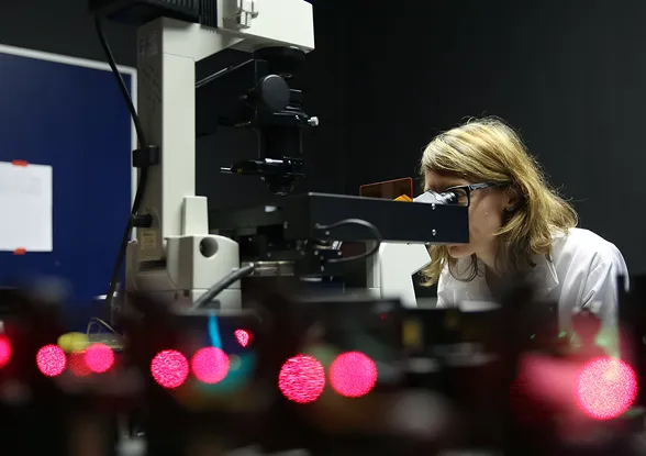 Scientist using a microscope
